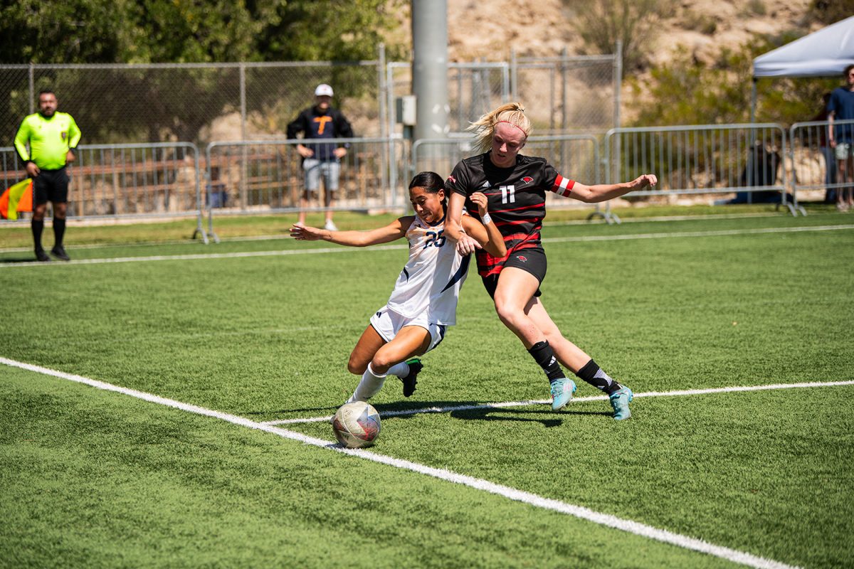 Forward leslie Gutierrez plays physical in attempt to save the ball leaving the pitch.