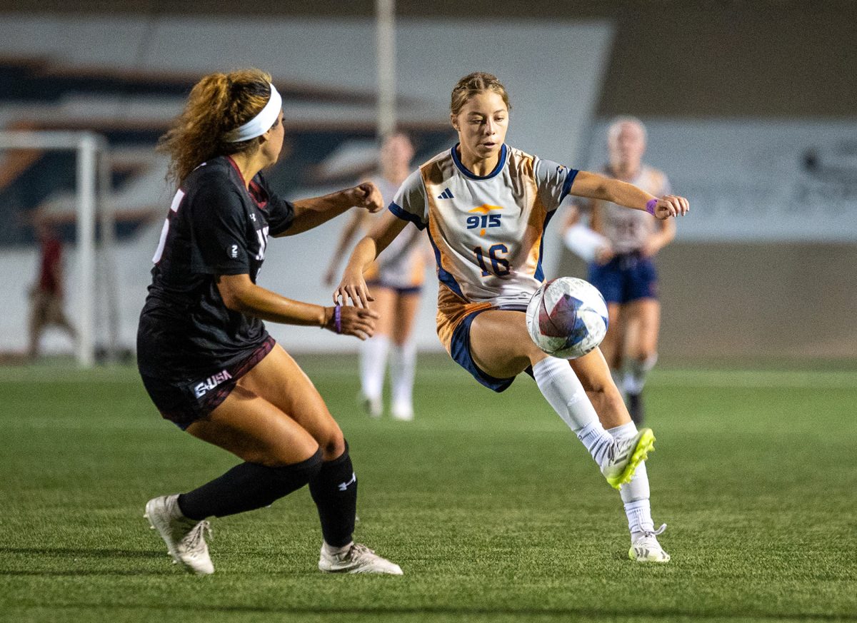 Forward+Jayde+Gone+kicks+the+ball+in+the+air+while+being+closely+defended+by+an+NMSU+player+on+Sept.+21.+