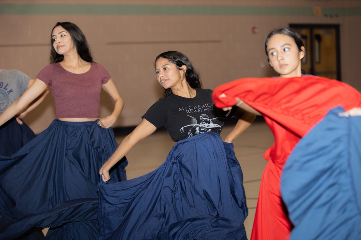 (From left to right) Malvina Muñoz, Alani Del La Cruz, and Victoria Muñoz dance to the song “La Llorona” at REL Washington Elementary School.  