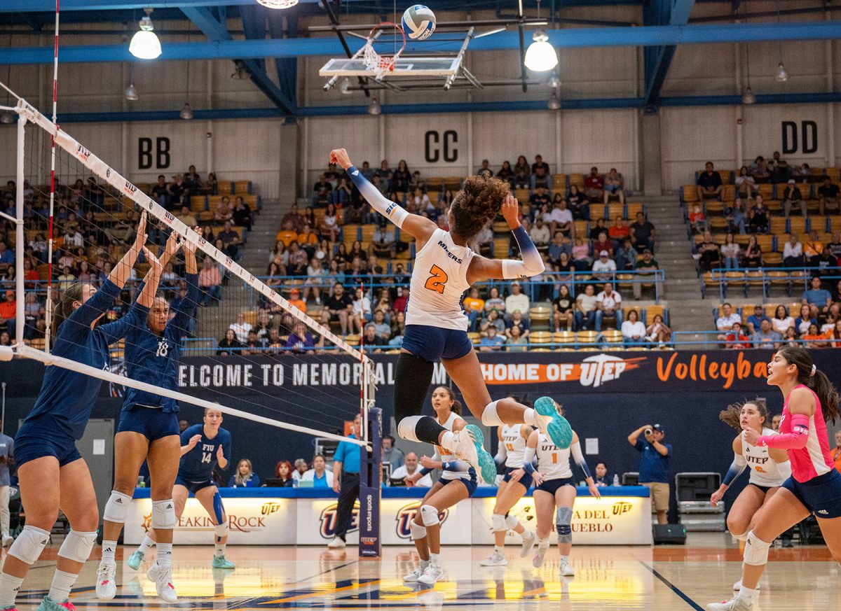 Outside hitter/middle blocker Alianza Darley jumps into the air to hit the ball during a set against FIU Oct. 7. 