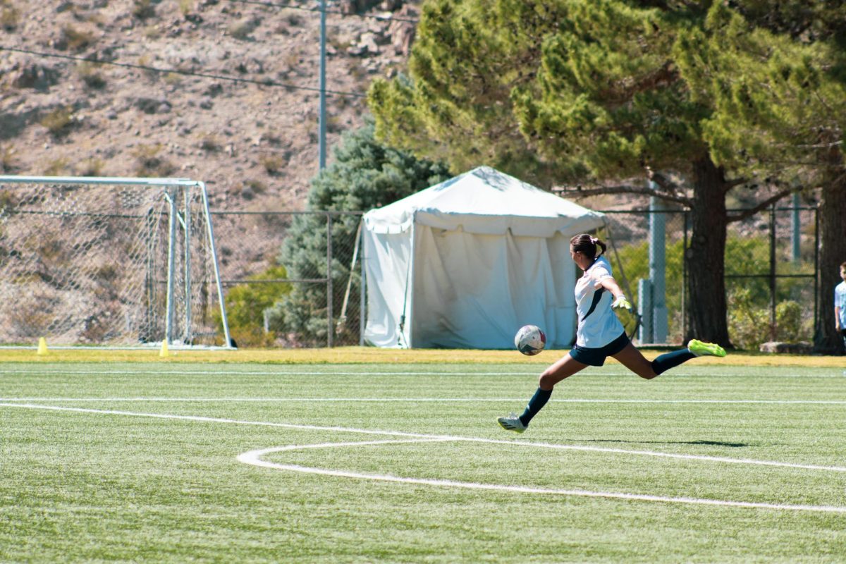 Goalkeeper Angelina Amparano kicks the ball towards UTEP players. 