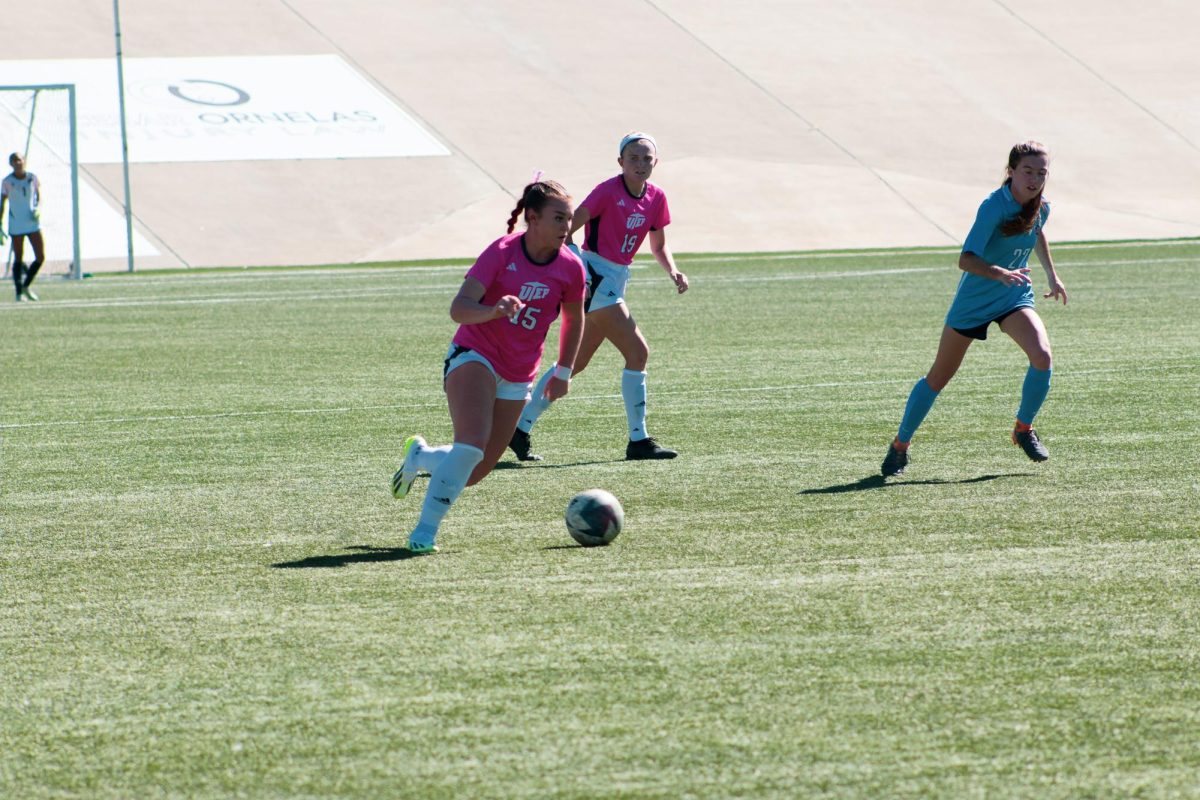 Midfielder Olivia Roskos attempts to advance the ball during match.  
