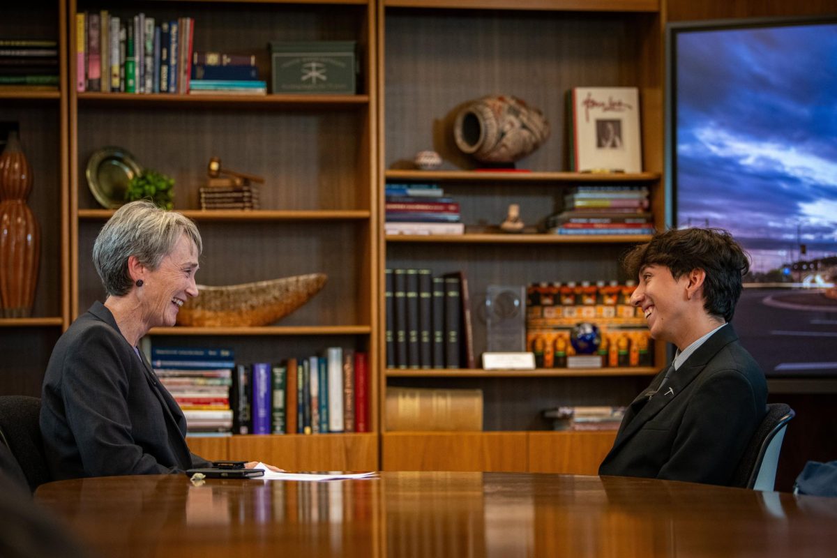 President Dr. Heather Wilson and Erik Acosta share a laugh together. 