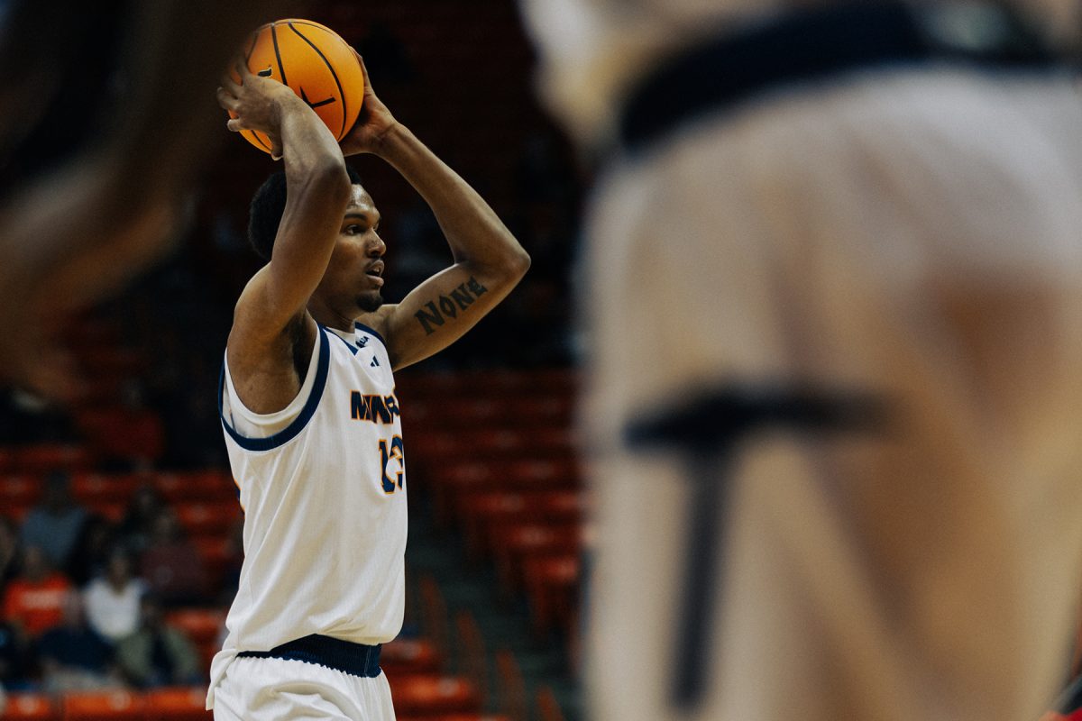 Forward Calvin Solomon looks for a teammate to pass the ball to.  
