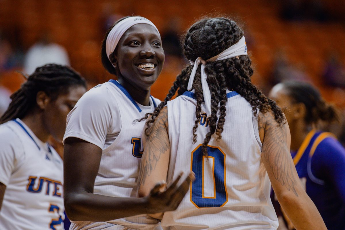 Forward Adhel Tac celebrates after a play with guard Mahri Petree.