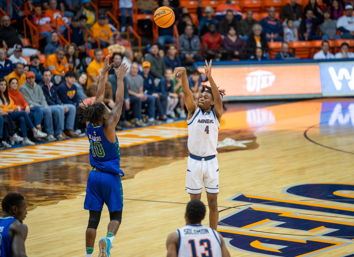 Guard Corey Camper Jr. Attempts to shoot the ball over the defense of Texas A&M-CC.