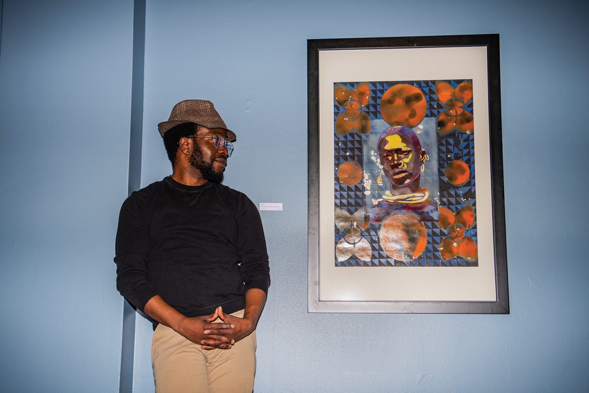 Rodney Tawanda Ph.D admires his own art as it is on display for Black History Month  