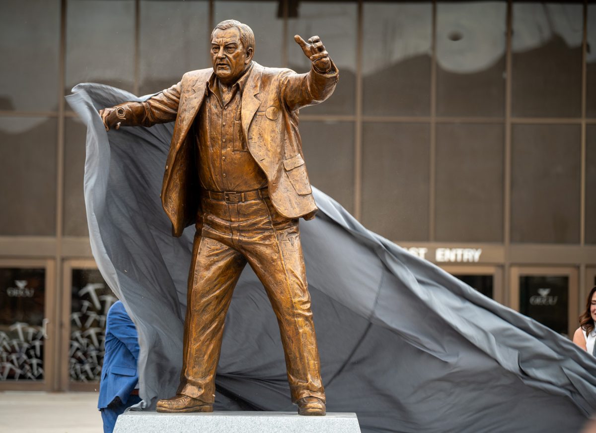 The sheet is removed to unveil the newly installed Don Haskins statue in front of the Don Haskins Center, Feb. 23.  