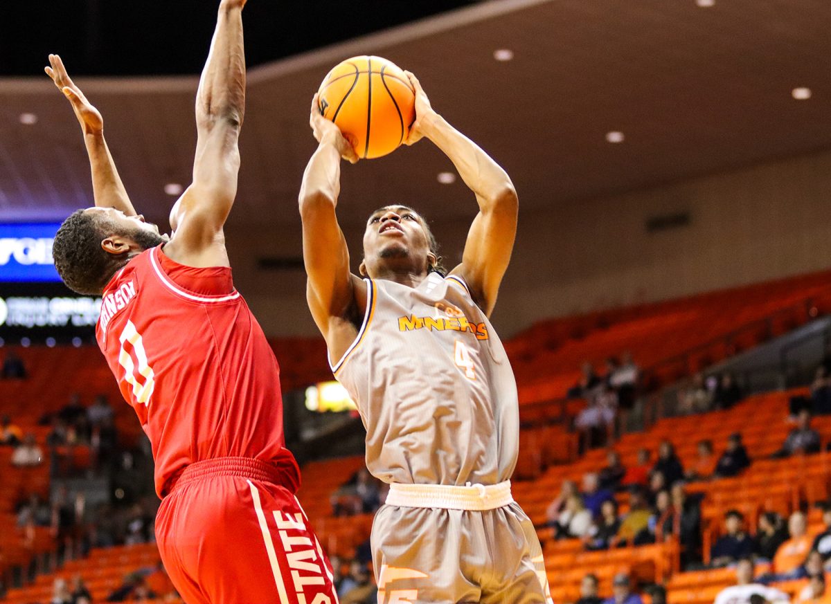 Junior guard Corey Camper attempts a shot against JAX State junior forward Caleb Johnson. 