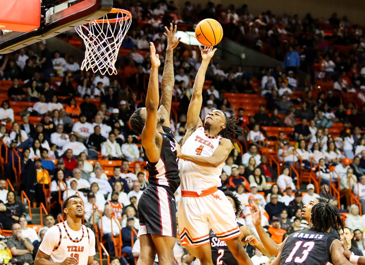 Junior guard Corey Camper Jr. attempts a shot against NMSU senior guard Femi Odukale. 