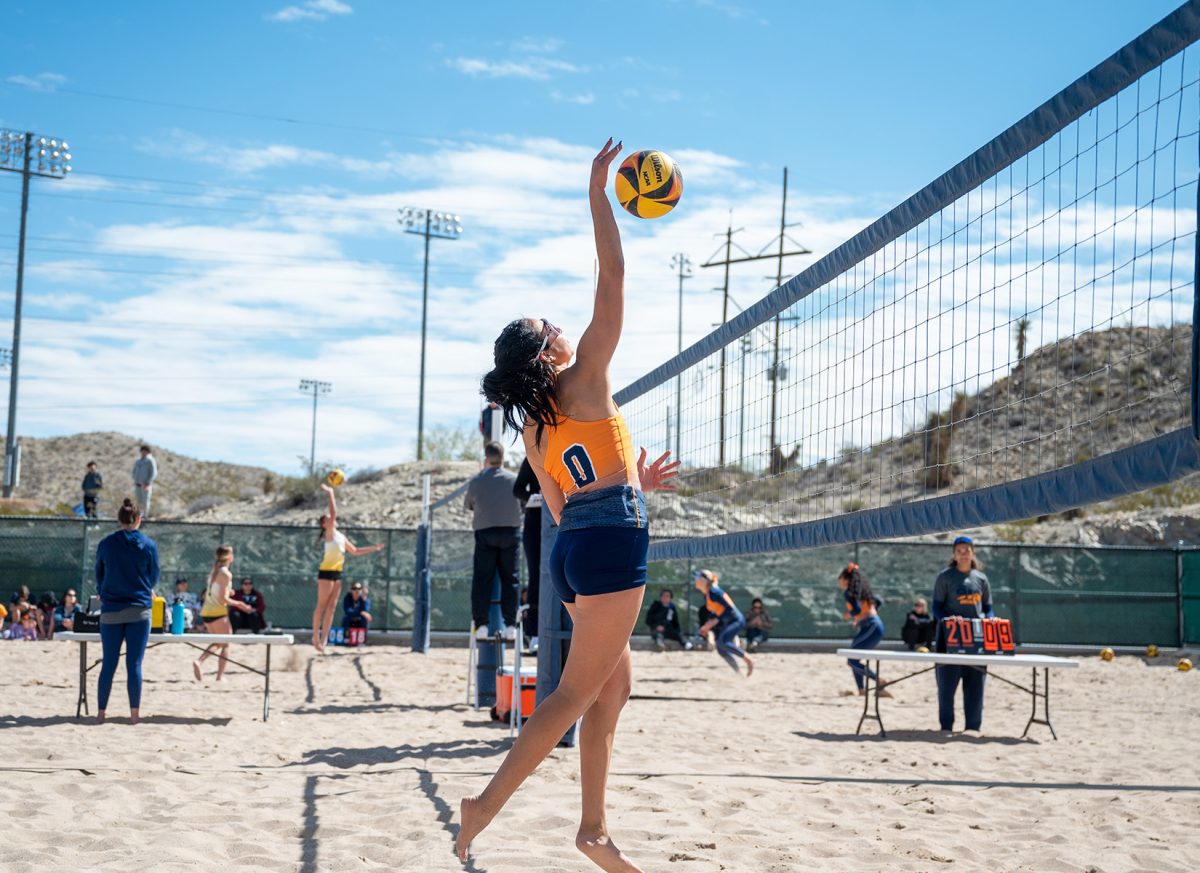 Freshman Adriana Oporto jumps high in the air and attempts to hit the ball.