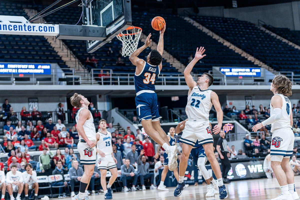 Junior+forward+Kevin+Kalu+jumps+up+in+attempt+to+lay+the+ball+over+the+defense+of+Liberty%2C+Mar.+14.+Photo+courtesy+of+UTEP+Athletics.