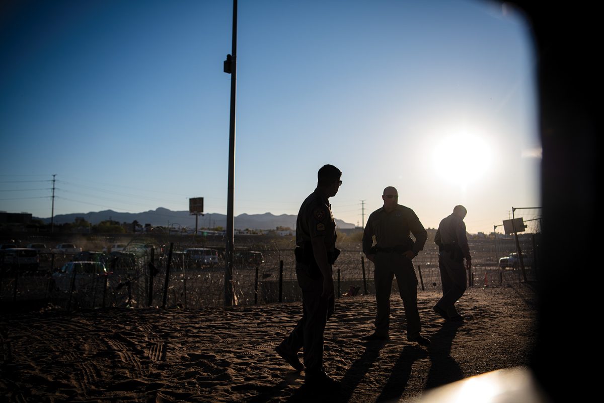 Border Patrol agents gather as they head towards a group of immigrants.