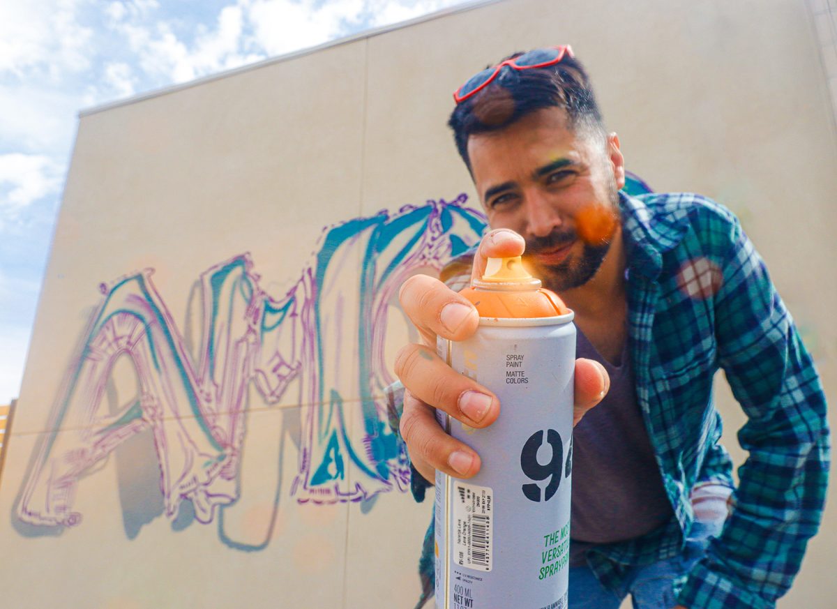 Tino Ortega works on upcoming “Amor” mural at 7715 Paseo del Norte Blvd.