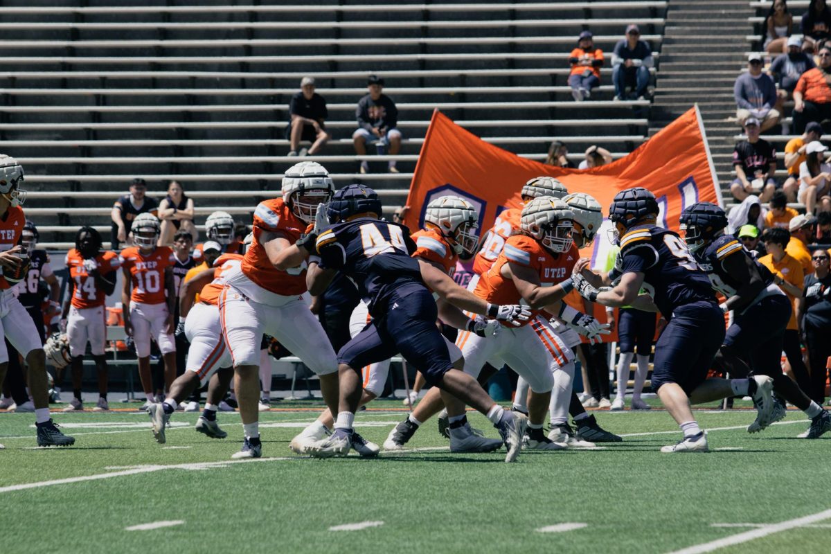 The offensive and defensive lines clash as the blue and orange teams battle during UTEP's 2025 Spring Game.