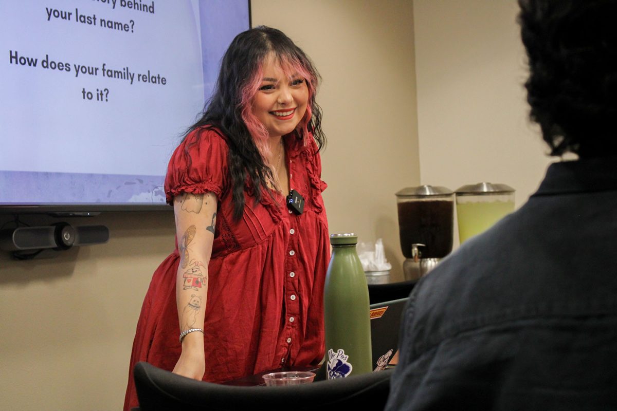 Instructor, Mariana Riestra listens to her students as they explain their writing piece reminiscing about memories growing up in a Hispanic family.  