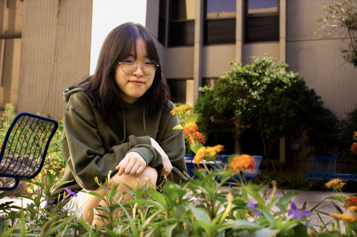 Getting a closer look at the garden, President Grace Lee gives examples of the community work and activities SEEDS has done. 