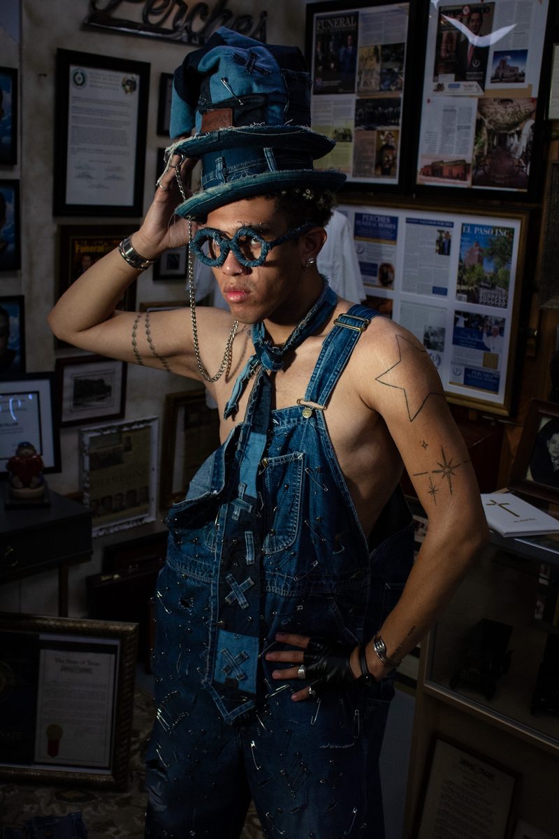 A model wears a crafted denim jumper, along with accessories such as glasses, a hat and a suitcase. This design was curated by one of the lead designers of the “Death by Denim” fashion show, Janice Walker.
