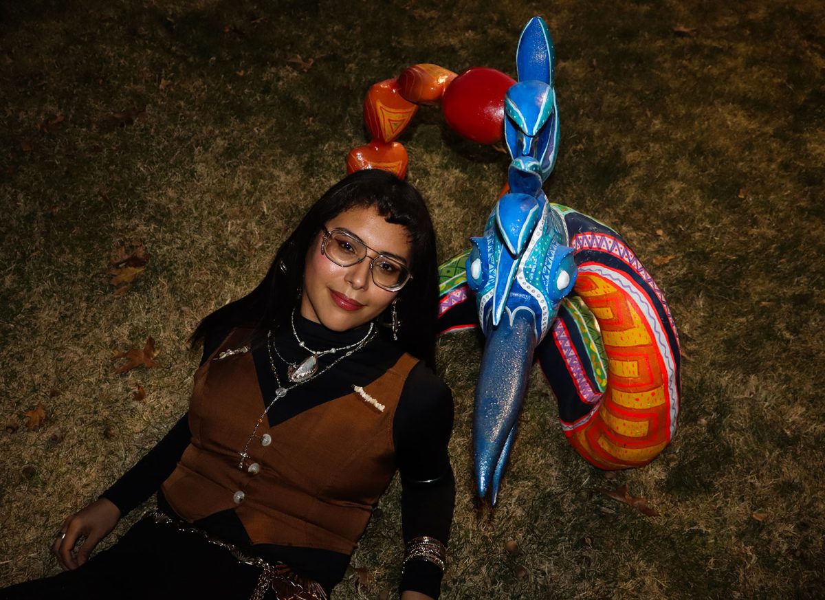 Priscila Ortiz poses with her Alebrije sculpture. Completing the piece in just one week, Ortiz blended traditional Mexican folk art with her own creative style.